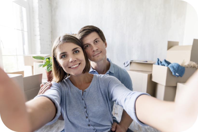 smiley couple taking selfie while packing move out